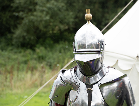 Kenilworth England  29th July  2023 A knight  puts  on his  helm  ready  for a joust   shining  helmet tight