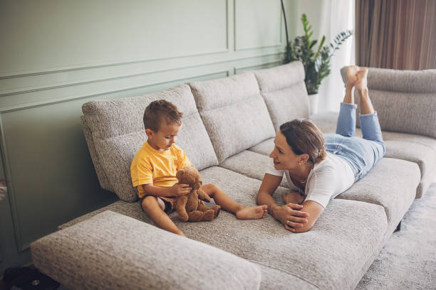 istock Mother and son relaxing on sofa 1729899844