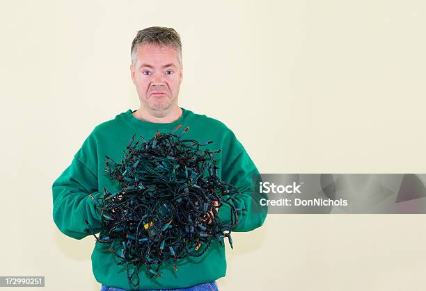 Foto de Homem Estressado De Natal e mais fotos de stock de Embaraçado - Embaraçado, Luz de Natal, Equipamento de Iluminação