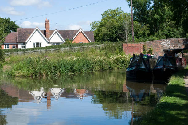 istock cottage house alongside canal 172990443