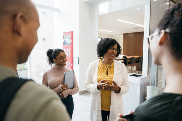 istock Teacher talks to students in University lobby 1729905192