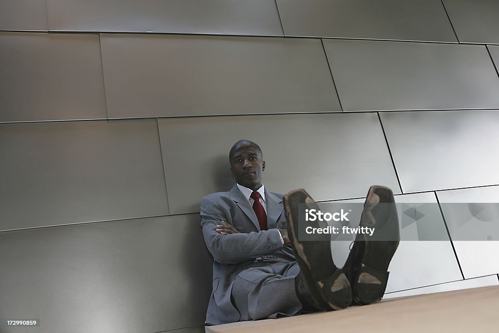 Seriously Pounding the Pavement African American man with soles worn out after searching for job Exhaustion Stock Photo