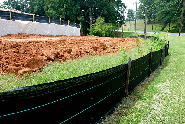 Silt fence erosion control at construction site Close-up view of silt fencing at construction site with bare dirt from grading in background eroded stock pictures, royalty-free photos & images