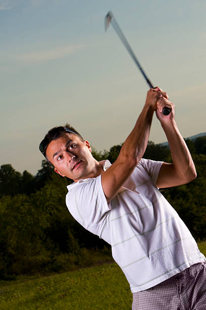 istock Golfer Takes Swing At Sunset 172991344