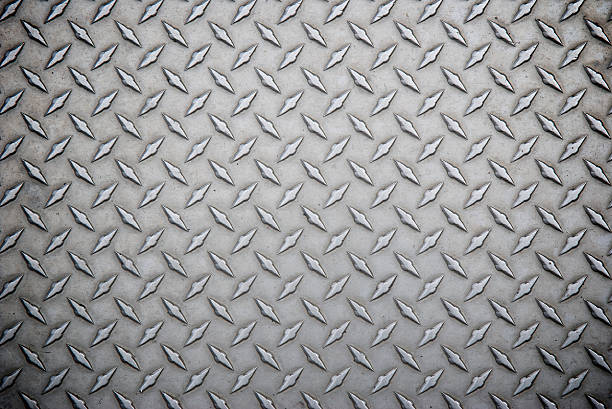 Worn Steel Diamond Tread Full Frame Background Full-frame background shot of well-worn textured diamond steel tread diamond plate stock pictures, royalty-free photos & images