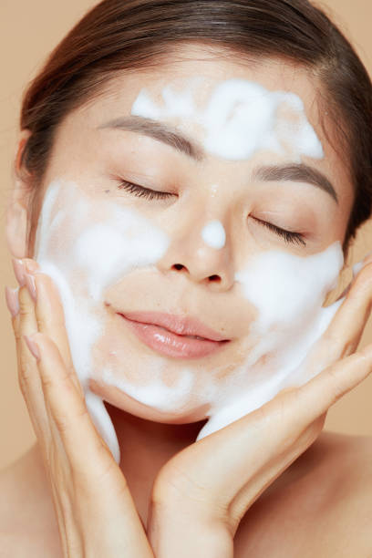 istock relaxed modern asian woman washing face 1729924077