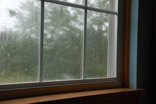 Rain drops on window glass outside texture with nature background