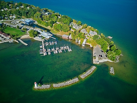 Aerial View of a Small Lake Side Town, Lighthouse, Peninsula and Marina