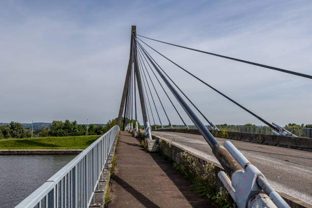 istock Pedestrian or cycling path parallel to rural road on Lanaye cable-stayed bridge 1729933505