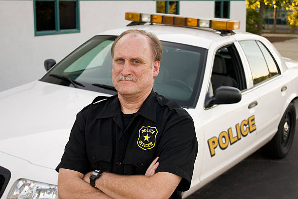 istock Police Officer and Patrol Car 172993455