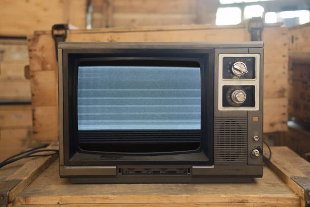istock An old TV with noise on the screen sits on a box. 1729944351