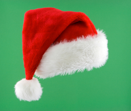 Santa hat isolated on green.