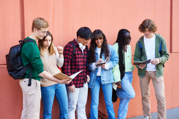 istock Students discussing homework outside school building 1729958337