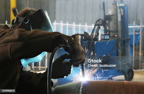 Welder Work Inside An Industrial Building Stock Photo - Download Image Now - Adult, Adults Only, Blue