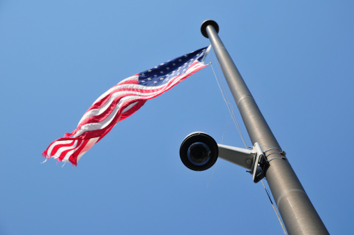 Small surveillance camera on an American flagpole
