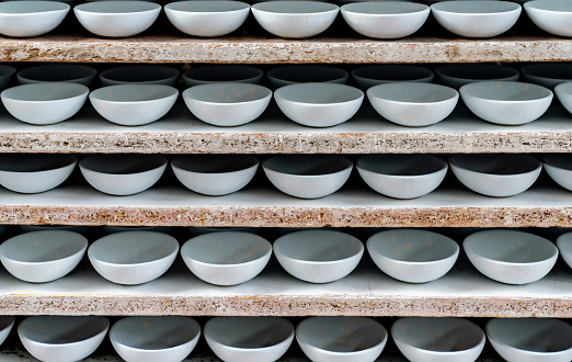 Beautiful ceramic bowls on a shelf at a pottery shop - small business concepts