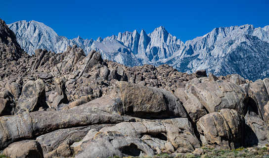The Alabama Hills are a range of hills and rock formations near the eastern slope of the Sierra Nevada in the Owens Valley, west of Lone Pine in Inyo County, California. The Sierra Nevada Mountains are in the back round with Mount Whitney.