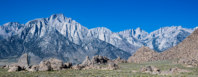 The Alabama Hills are a range of hills and rock formations near the eastern slope of the Sierra Nevada in the Owens Valley, west of Lone Pine in Inyo County, California. The Sierra Nevada Mountains are in the back round with Mount Whitney.