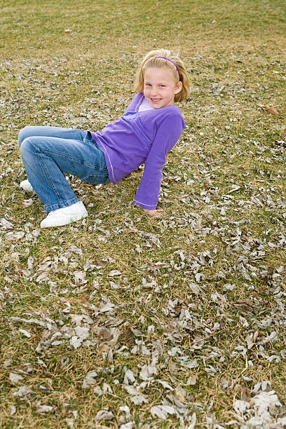 crab walk girl a young blonde playning in the backyard after the leaves started to fall person falling backwards stock pictures, royalty-free photos & images