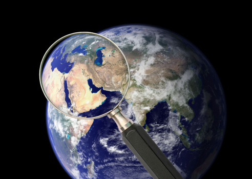 Earth through the magnifying lens. Concept photo. Source image of Earth: http://earthobservatory.nasa.gov