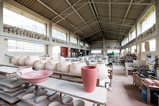 Beautiful pottery pieces in a storage room at a ceramics factory - manufacturing business concepts