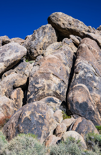 Magmatic Dike or dyke is a sheet of rock that is formed in a fracture of a pre-existing rock body. The Alabama Hills are a range of hills and rock formations near the eastern slope of the Sierra Nevada in the Owens Valley, west of Lone Pine in Inyo County, California. The Sierra Nevada Mountains are in the back round.