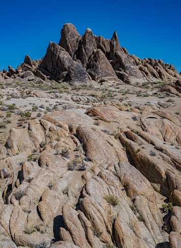Magmatic Dike or dyke is a sheet of rock that is formed in a fracture of a pre-existing rock body. The Alabama Hills are a range of hills and rock formations near the eastern slope of the Sierra Nevada in the Owens Valley, west of Lone Pine in Inyo County, California. The Sierra Nevada Mountains are in the back round.