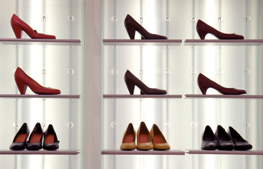 Womens heeled shoes in orderly fashion on display.