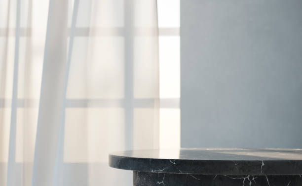 istock Empty black marble table in front of window with white curtains. 1729986508