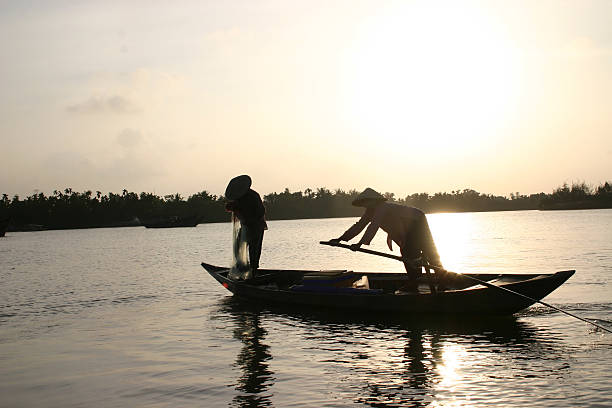 Fishermen of  Vietnam Hoi An Sunset stock photo