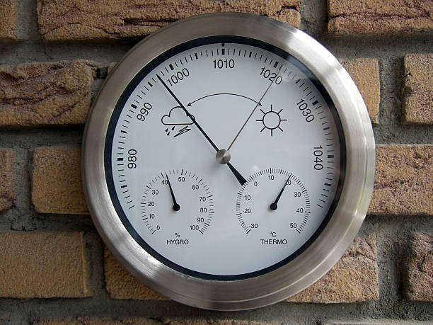 weather station hanging on stone wall