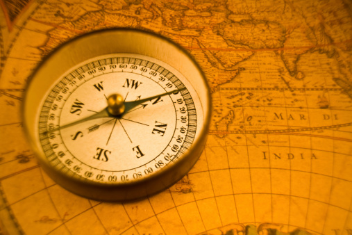 Vintage compass over antique map. T&S lens for selective focus.