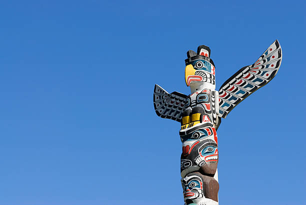 Totem Pole in Vancouver, BC, Canada "Totem pole in Stanley Park, Vancouver, with copy space" totem pole stock pictures, royalty-free photos & images