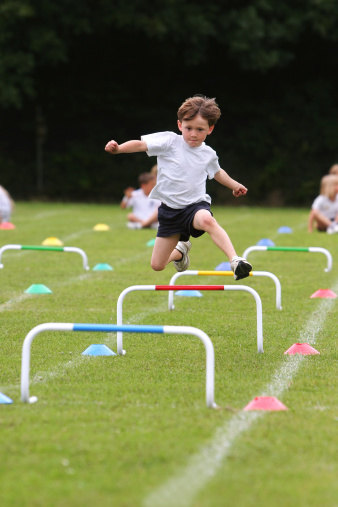 A young boy races along at a school sports day.