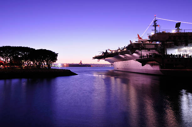 Overview of the midway at dusk The USS Midway at Dusk in San Diego,CA. landing craft stock pictures, royalty-free photos & images