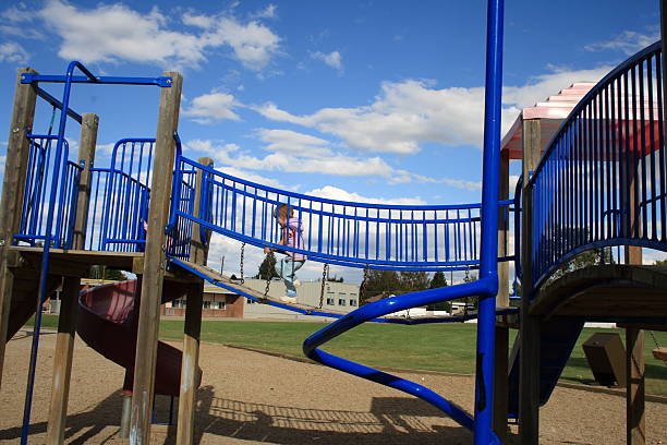 istock little girl runs across bridge on playground structure 173001375
