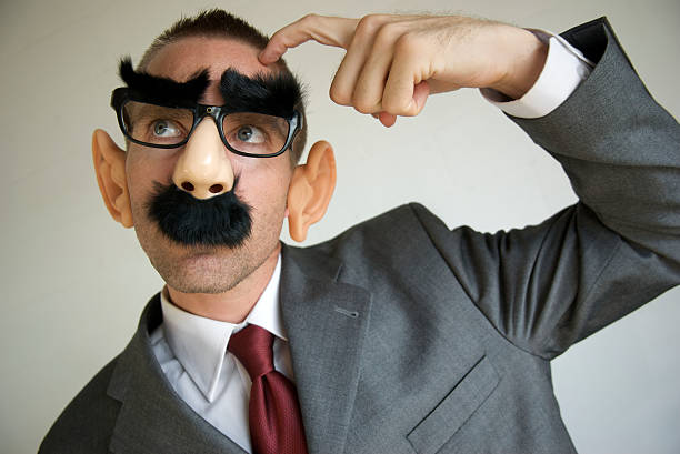 istock Businessman with Funny Disguise Scratches Head 173002533