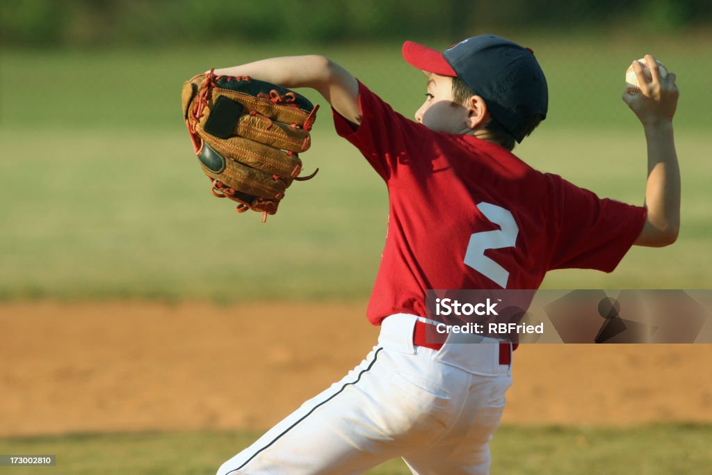 Child pitching for a baseball game a boy pitching Adolescence Stock Photo