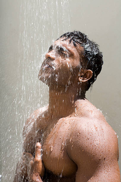 attractive man showers nude stock photo
