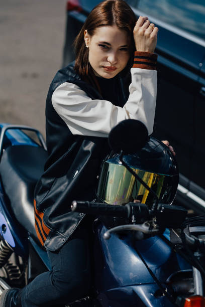 istock beautiful young female motorcyclist sits on a motorcycle. 1730030929