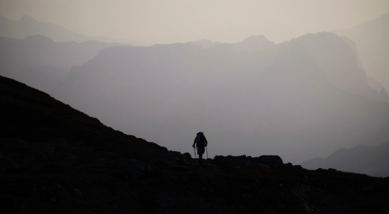 wanderer silhouette in the morning at peak of mountain