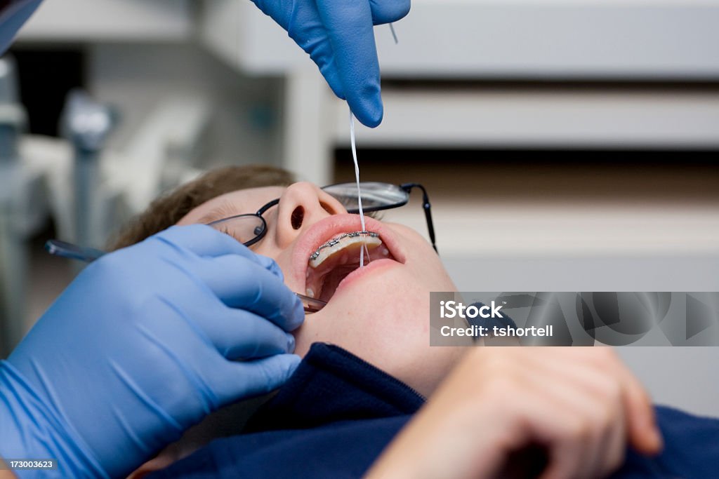 Boy getting braces adjusted A boy has his braces cleaned and adjusted at the orthodontist. Boys Stock Photo