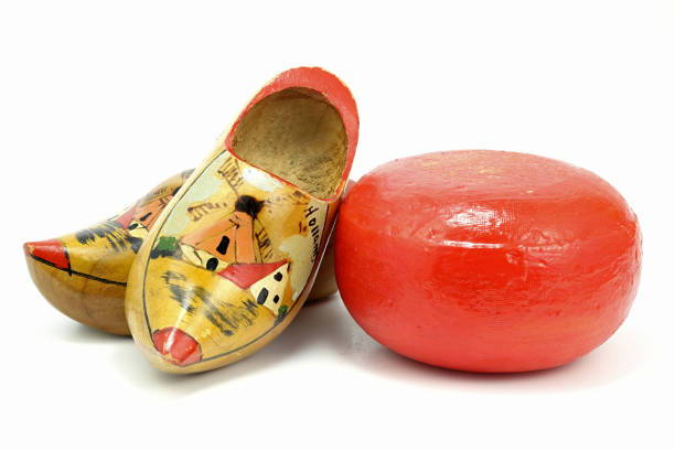 istock Edam cheese wheel with nostalgic Dutch souvenir clogs 1730040772