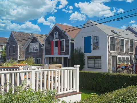 Traditional row of Cape Cod cottages lined up along Commercial street in Provincetown.