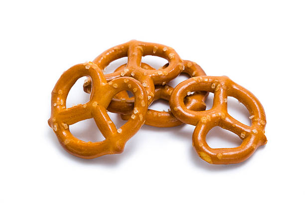 Pretzels in a pile isolated on white Small pretzels with salt. pretzel photos stock pictures, royalty-free photos & images