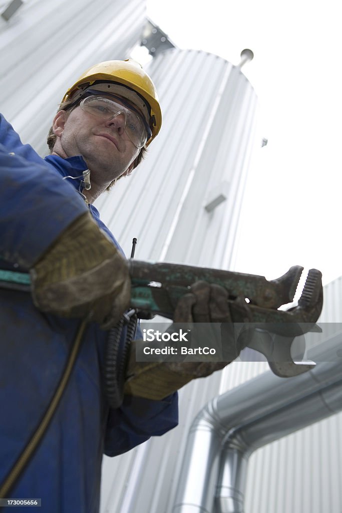 Repairman and mechanic at work with his tools. If you want more images with a construction worker (with tools) please click her. Blue-collar Worker Stock Photo