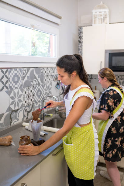 istock Baker filling a piping bag to decorate a cake 1730057452