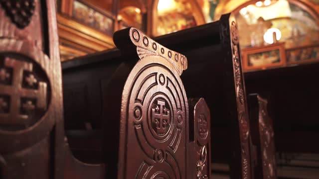 Close-up of wooden bench with carvings cross on the side in The Coptic Orthodox Church