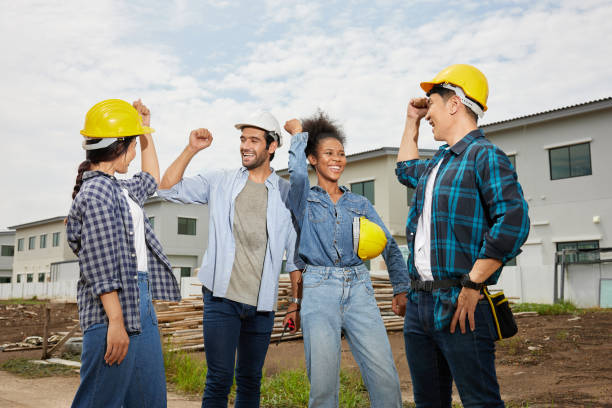 istock group of workers or architect celebrating success at work and project on the construction site 1730064925