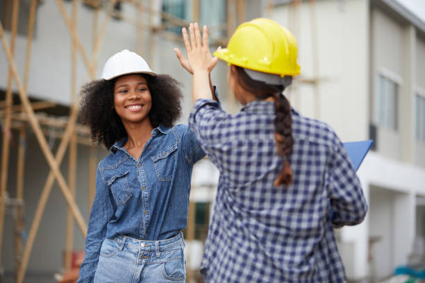 istock African worker or architect giving hi five pose celebrating success at work on the construction site 1730069754